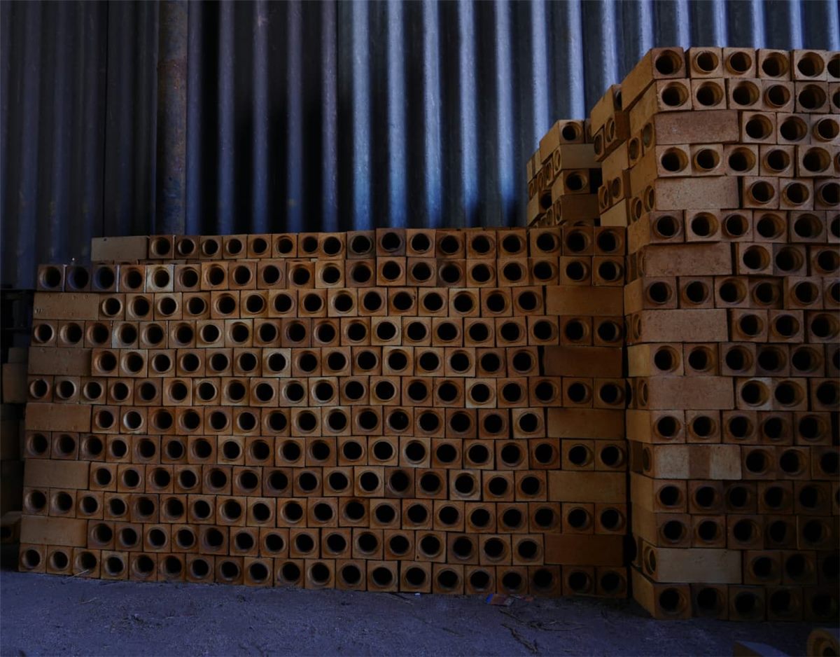 Stacked perforated refractory bricks
