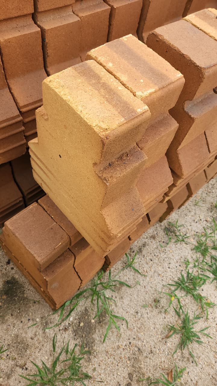 Shaped fireclay refractory bricks stacked outdoors