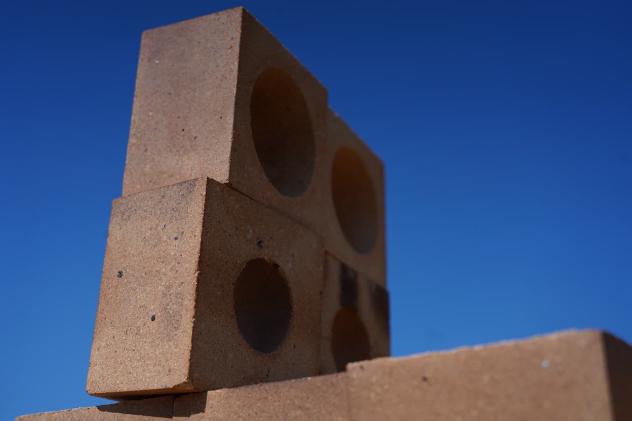 Stacked refractory bricks with round holes, low angle