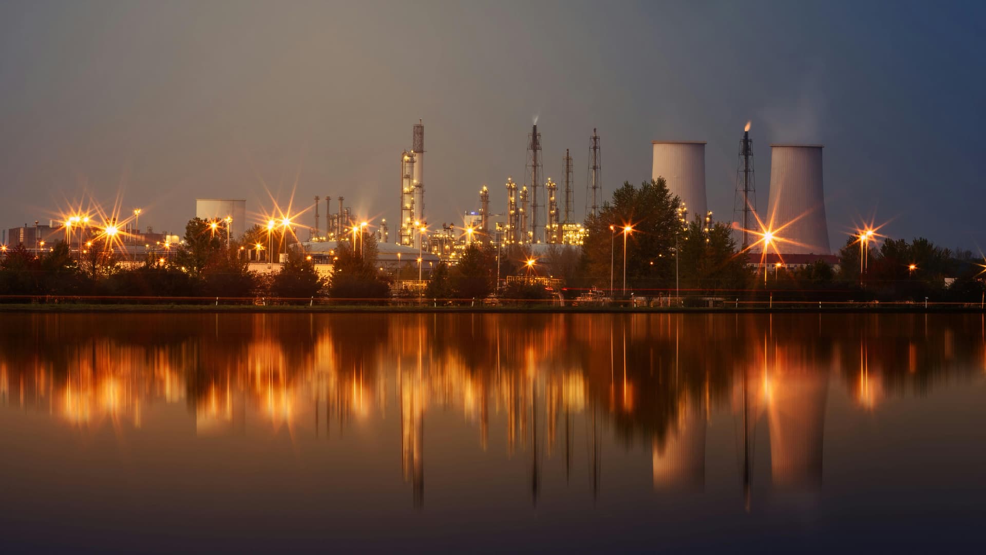 Industrial facility reflected at sunset