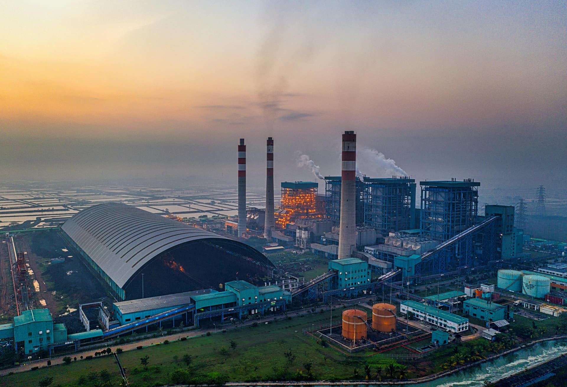 Aerial view of an industrial refractory manufacturing facility at dusk